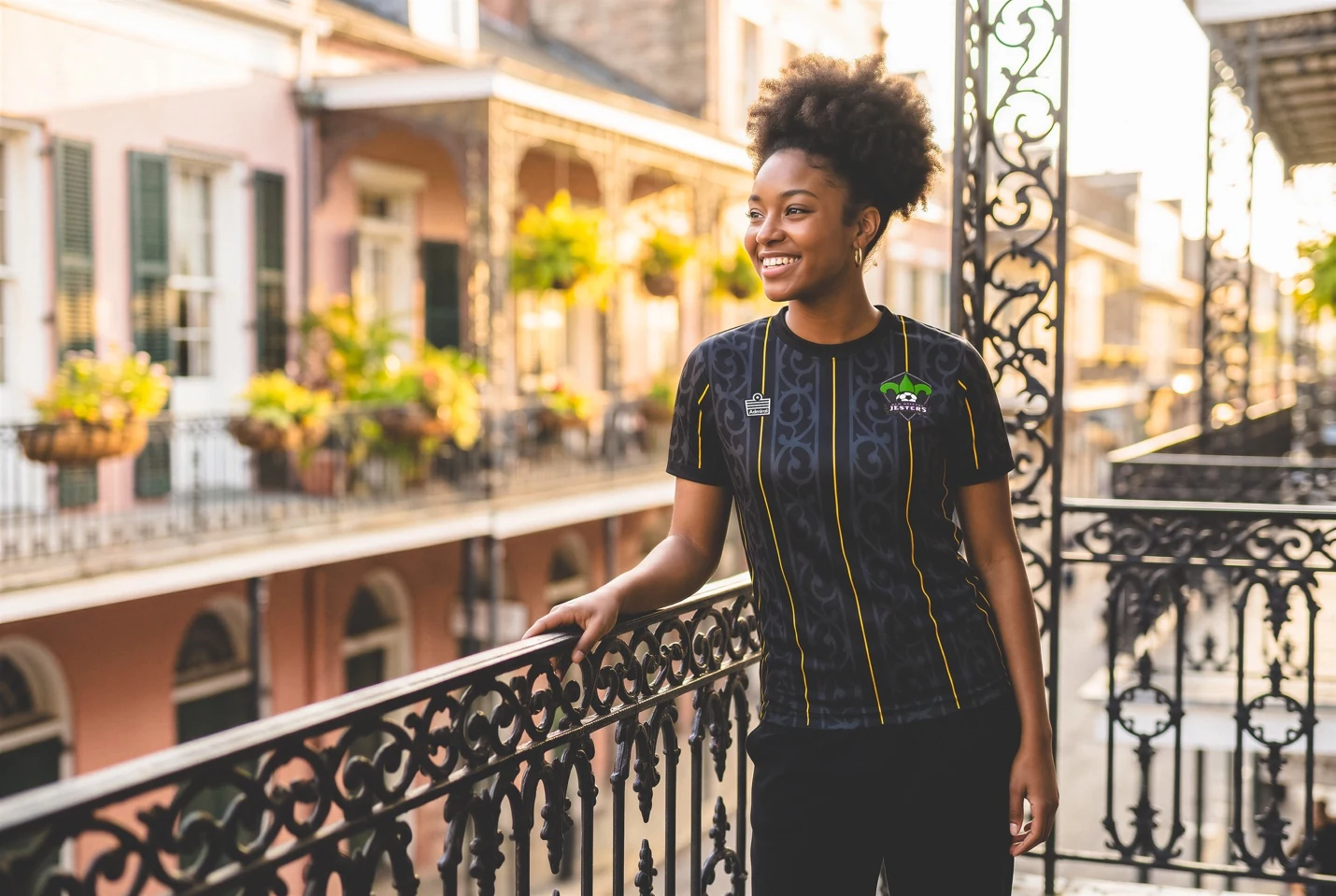 A player wearing the black and gold Jesters alternate shirt on a French Quarter balcony
